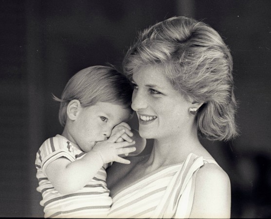 Young Prince Harry tries to hide behind his mother Princess Diana during a morning picture session at Marivent Palace on August 9, 1988. Princess Diana