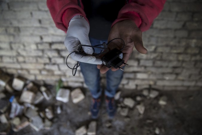 Man holds a mobile phone charger
