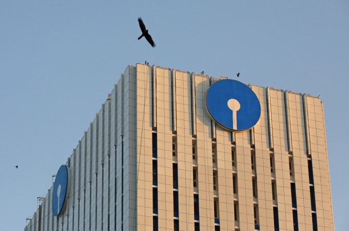 Birds fly past the headquarters of State Bank of India in Mumbai, India, March 9, 2016. State Bank of India home loans to women