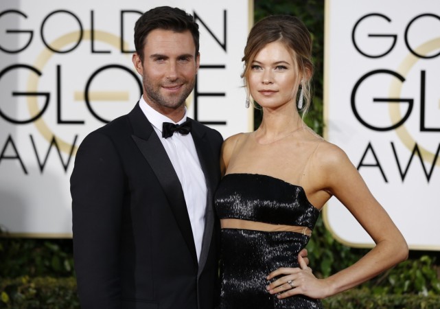 Adam Levine and wife Behati Prinsloo's daughter is beautiful, says insider. Pictured: Maroon 5 singer Adam Levine (L) arrives with his wife model Behati Prinsloo at the 72nd Golden Globe Awards in Beverly Hills, California January 11, 2015. Adam Levine