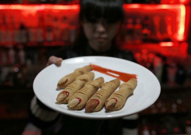 Pictured: A waitress shows cookies in the shape of chopped fingers. Halloween