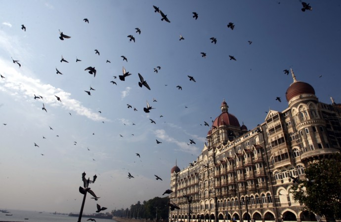 Pigeons fly around Taj Mahal hotel in Mumbai December 22, 2008. Mumbai