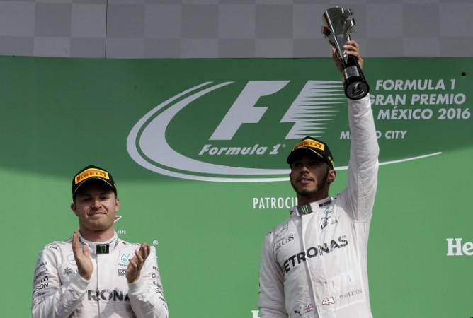 Lewis Hamilton (R) and Nico Rosberg celebrate on the podium after finishing first and second respectively in the Mexican Grand Prix, October 30, 2016 Nico Rosberg Lewis Hamilton