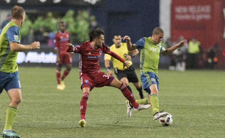 FC Dallas forward Maximiliano Urruti (37) and Seattle Sounders FC midfielder Osvaldo Alonso (6) fight for the ball during the first half at CenturyLink Field. Seattle Sounders FC defeated FC Dallas 3-0. Seattle Sounders v FC Dallas