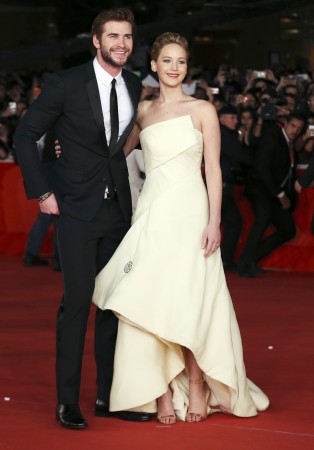Jennifer Lawrence (R) and Liam Hemsworth at the screening of the movie Liam Hemsworth and Jennifer Lawrence