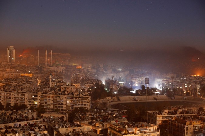 Smoke and flames rise after air strikes in Syria Reuters