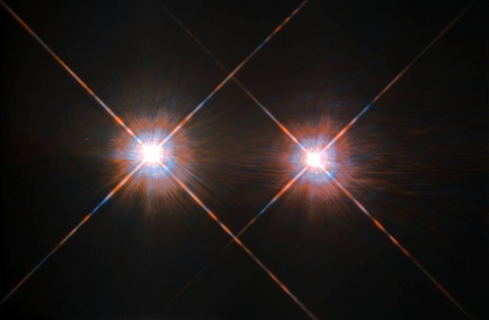 Alpha Centauri group, the closest star system to the Earth is located in the constellation of Centaurus (The Centaur), at a distance of 4.3 light-years. This NASA/ESA Hubble Space Telescope has given us this stunning view of the bright Alpha Centauri A (on the left) and Alpha Centauri B (on the right), shining like huge cosmic headlamps in the dark. The image was captured by the Wide-Field and Planetary Camera 2 (WFPC2). Alpha Centauri