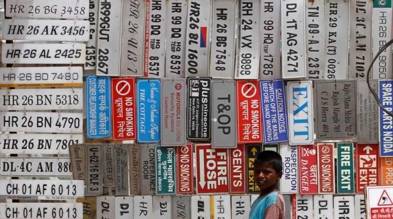 (Representational image)A boy stands in front of displayed car number plates and other signs at an automobile market in Gurgaon on the outskirts of New Delhi June 7, 2012 Indian vehicle number plate