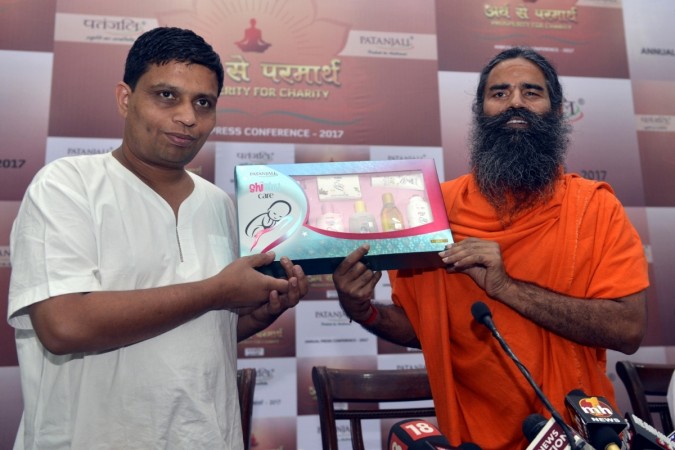 BRAND BULLDOZERS: Yoga guru Ramdev and Patanjali Ayurved MD Acharya Balkrishna at a product launch in New Delhi on May 4 this year. Baba Ramdev and Acharya Balkrishna