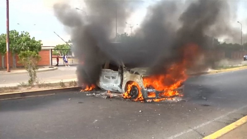 A Car is torched amid protests in Venezuela 20-year-old killed during Venezuela protest as death toll keeps rising