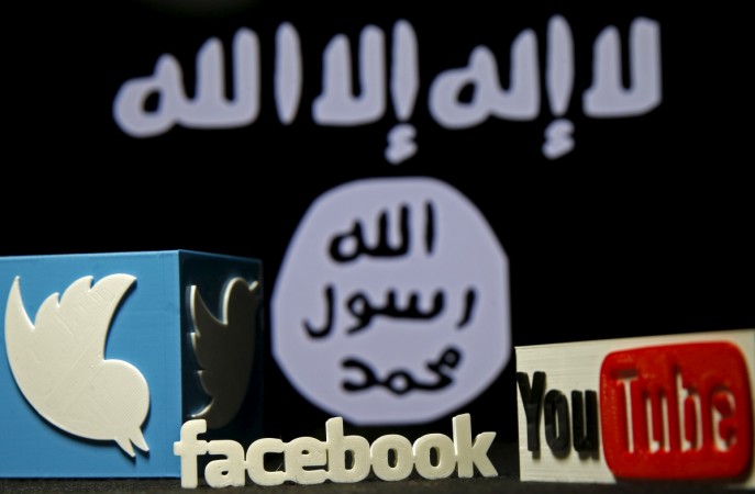 A 3D plastic representation of the Twitter and YouTube logo is seen in front of a displayed ISIS flag in this photo illustration in Zenica, Bosnia and Herzegovina, February 3, 2016. Youtube online extremism