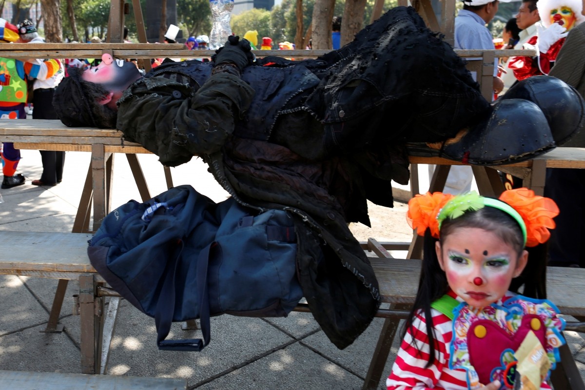 A clown rests during the XXI Convention of Clowns, at the Jimenez Rueda Theatre, in Mexico City, Mexico, October 19, 2016.