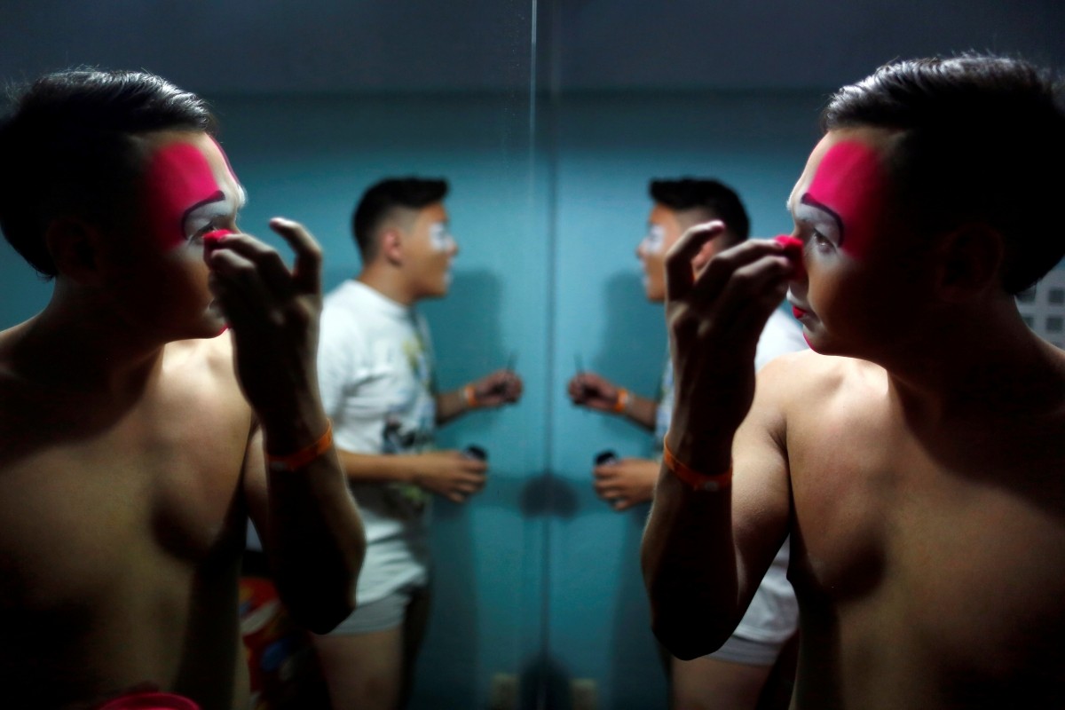 Eduardo Baquera, known as Cocoy Clown, puts on makeup during the XXI Convention of Clowns, at the Jimenez Rueda Theatre, in Mexico City, Mexico, October 19, 2016.
