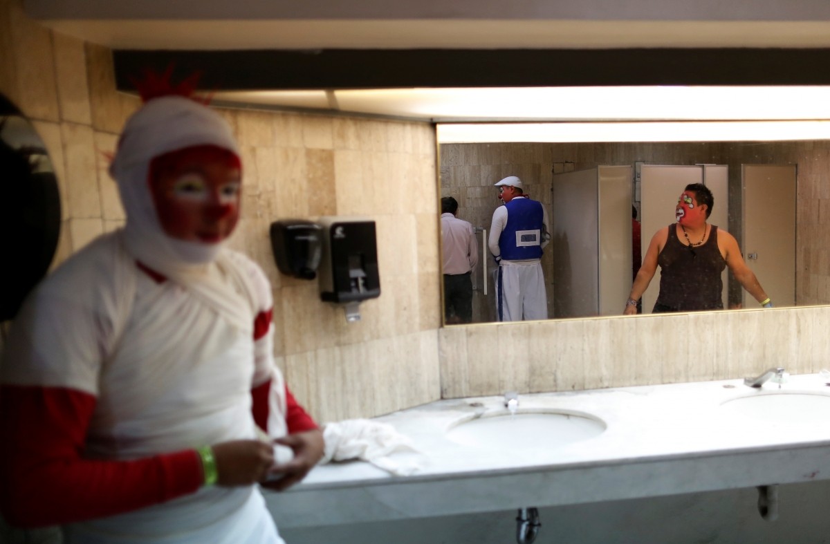 A group of clowns are seen in the toilet during the XXI Convention of Clowns, at the Jimenez Rueda Theatre, in Mexico City, Mexico, October 19, 2016.