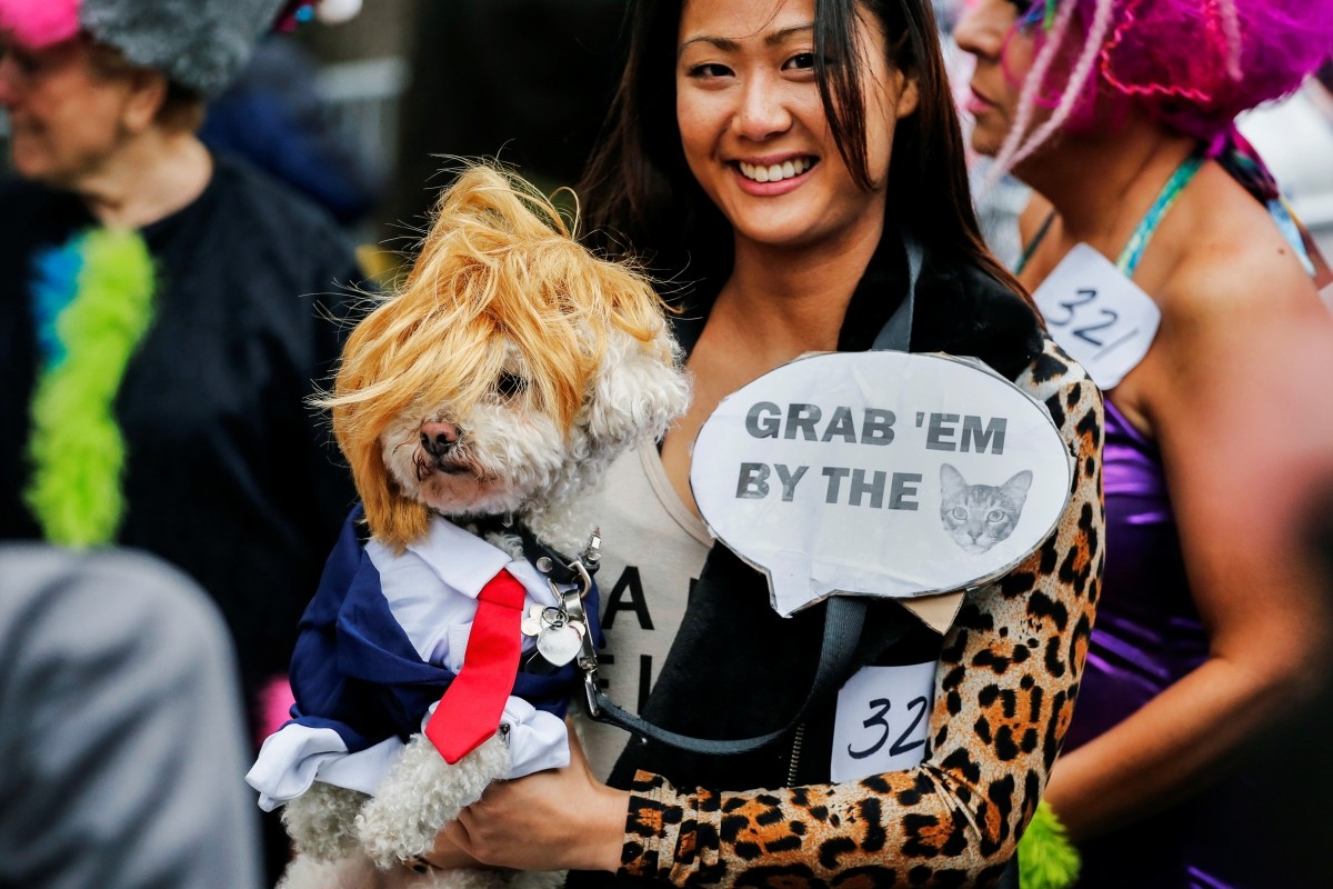 A reveller carries her dog which is depicted as Republican U.S. presidential nominee Donald Trump during the annual halloween dog parade at Manhattan's Tompkins Square Park in New York, U.S. October 22, 2016.