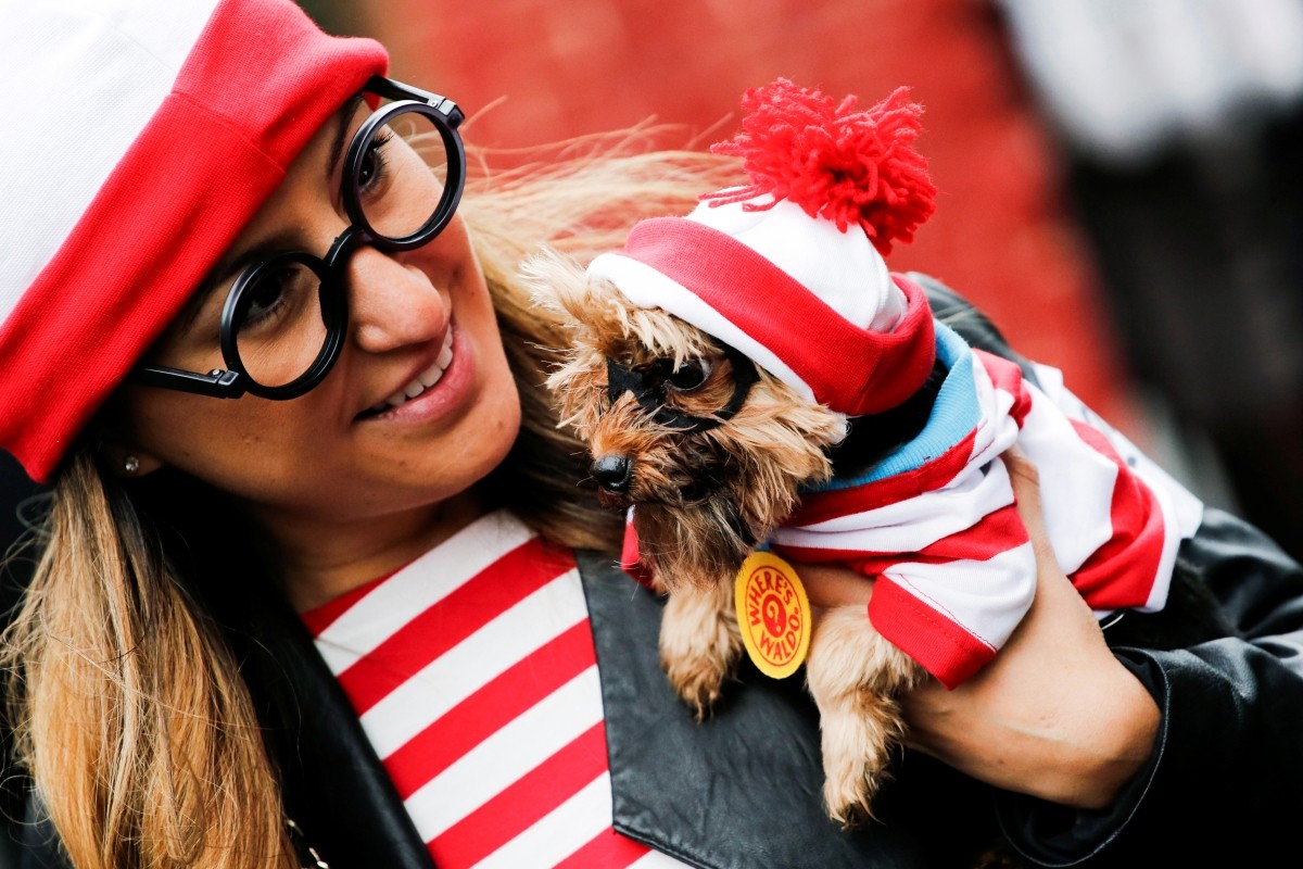 A reveller takes part in the annual halloween dog parade at Manhattan's Tompkins Square Park in New York, U.S. October 22, 2016.
