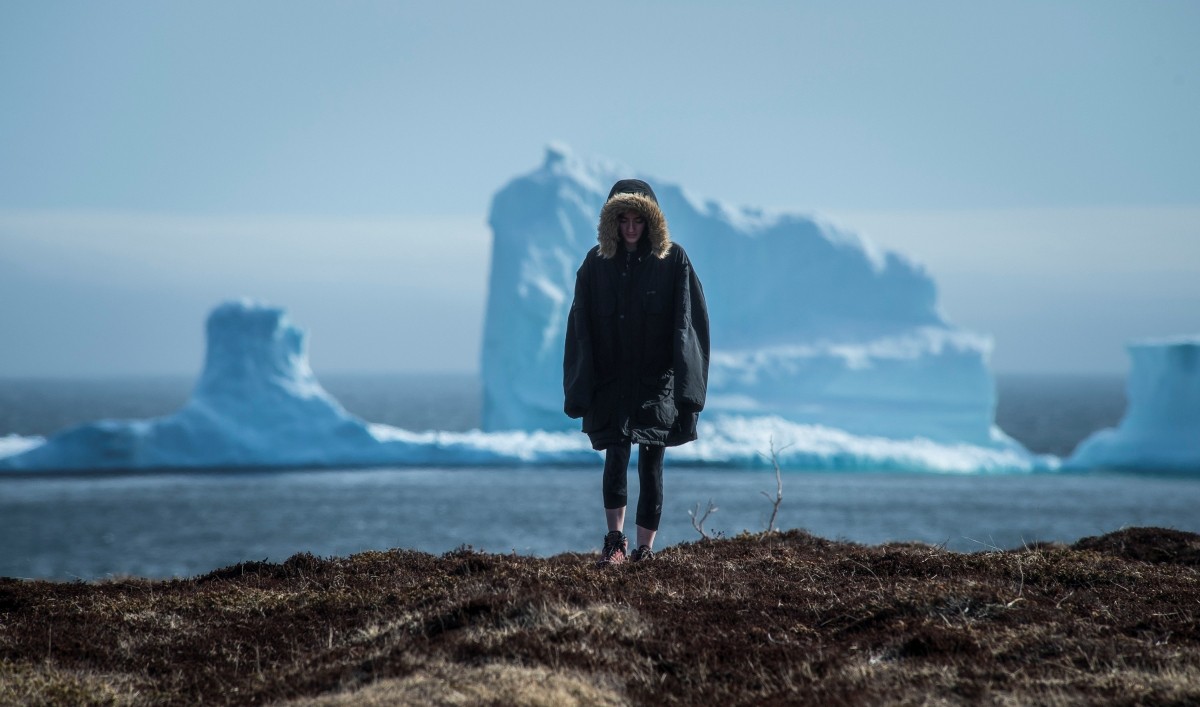 A resident views the first iceberg of the season as it passes the South Shore, also known as Canada iceberg