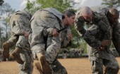 U.S. Army First Lieutenant Kirsten Griest (C) and fellow soldiers participate in combatives training during the Ranger Course on Fort Benning, Georgia.
