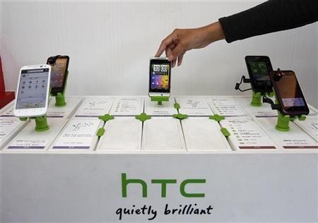 A shop attendant arranges HTC phones in a mobile phone store in Taipei November 24, 2011. A shop attendant arranges HTC phones in a mobile phone store in Taipei November 24, 2011.