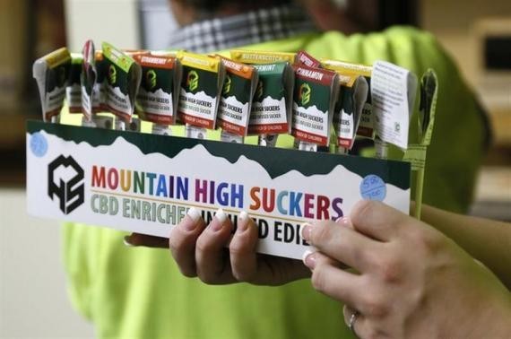 n employee brings out a display of drug-infused candies at the Botana Care marijuana store just before opening the doors to customers for the first time in Northglenn, Colorado January 1, 2014.