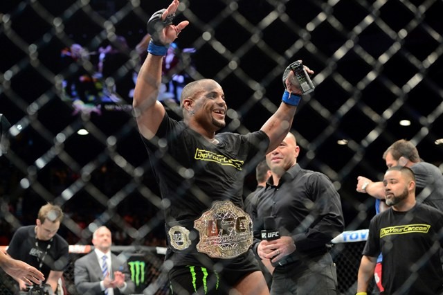 Daniel Cormier celebrates after defeating Anthony Johnson (not pictured) in their Light Heavyweight championship bout at UFC 187 daniel cormier