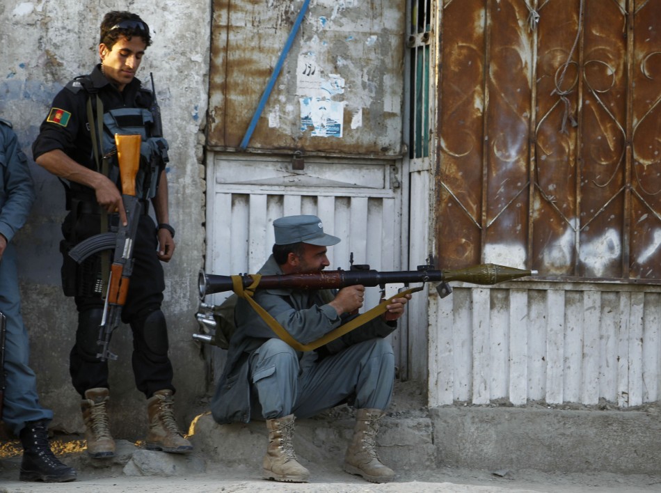 Afghan policemen take position at the site of an attack in Kabul April 15, 2012. Gunmen launched multiple attacks in the Afghan capital Kabul on Sunday, assaulting Western embassies in the heavily guarded, central diplomatic area and at the parliament in the west, witnesses and officials said. Taliban Attack in Kabul