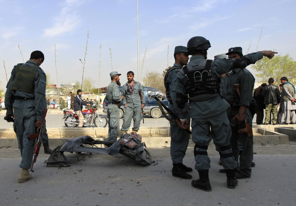 Afghan policemen stand around the wreckage of a car used by a suicide attacker in Kabul April 16, 2012. Heavy street fighting between militants and security forces in the centre of the Afghan capital Kabul ended on Monday after 18 hours of intense gunfire, rocket attacks and explosions, police and government officials said. Taliban Attack
