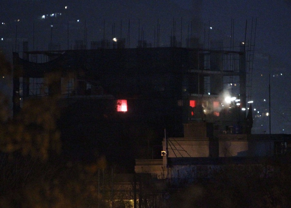 Sparks from a fire caused by an explosion are seen at a construction site during a battle between Afghan forces and Taliban insurgents including suicide bombers in Kabul April 16, 2012. Taliban Attack in Kabul