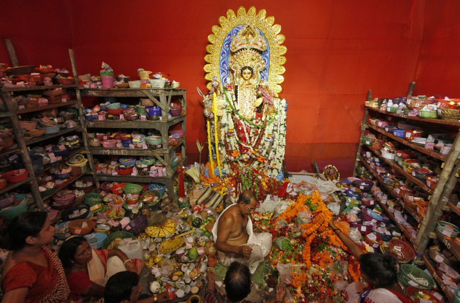 A Hindu priest worships Sheetala Mata, the Hindu goddess of smallpox, near prayer items during the Sheetala Puja in Kolkata May 5, 2012. During the Puja, women fast for the whole day to pray for the betterment of their family and society. The Week That Was (PHOTOS)