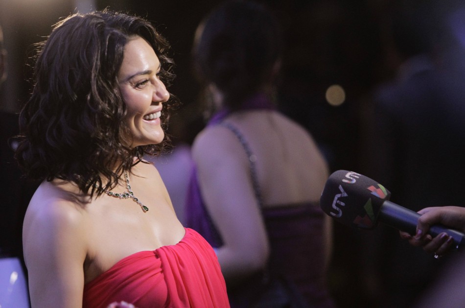 Bollywood actress Preity Zinta smiles while speaking to a reporter upon her arrival on the green carpet for IIFA Awards show in Singapore IIFA Awards 2012
