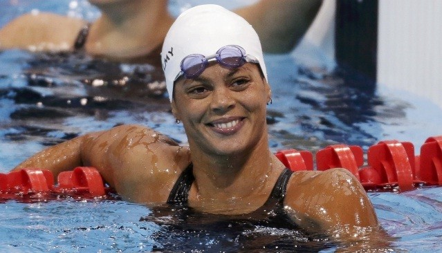 France's Coralie Balmy waves after placing first in heat 4 of the women's 400m freestyle event during the London 2012 Olympic Games at the Aquatics Centre Coralie Balmy