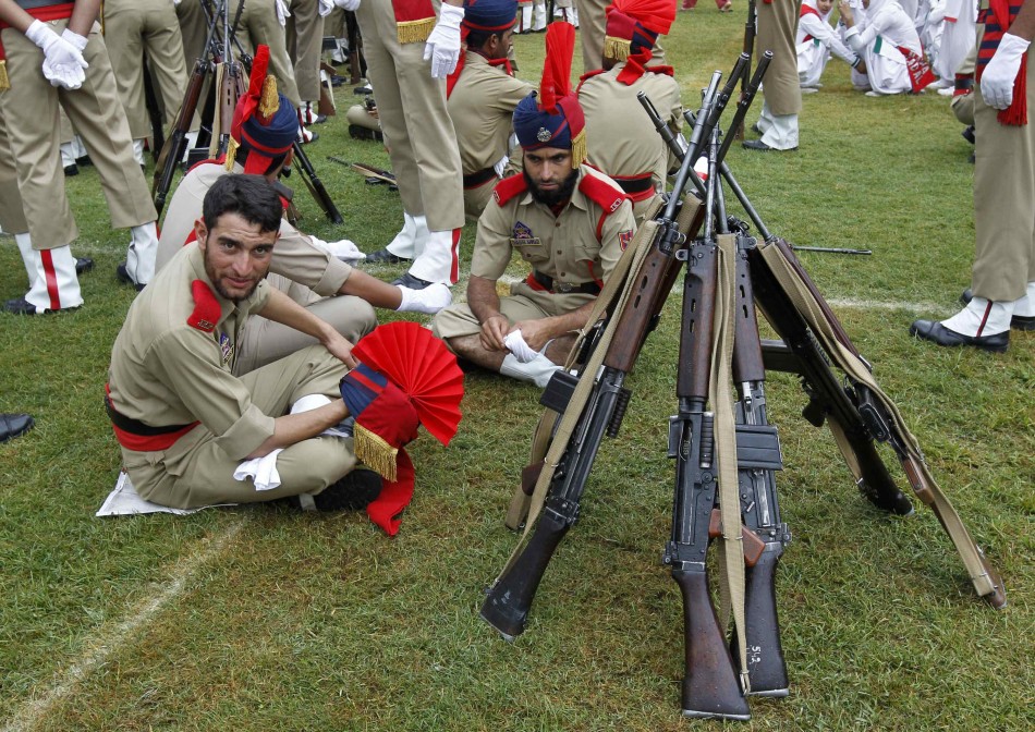 Policemen rest near their weapons before the start of India's Independence Day celebrations in Srinagar Independence Day