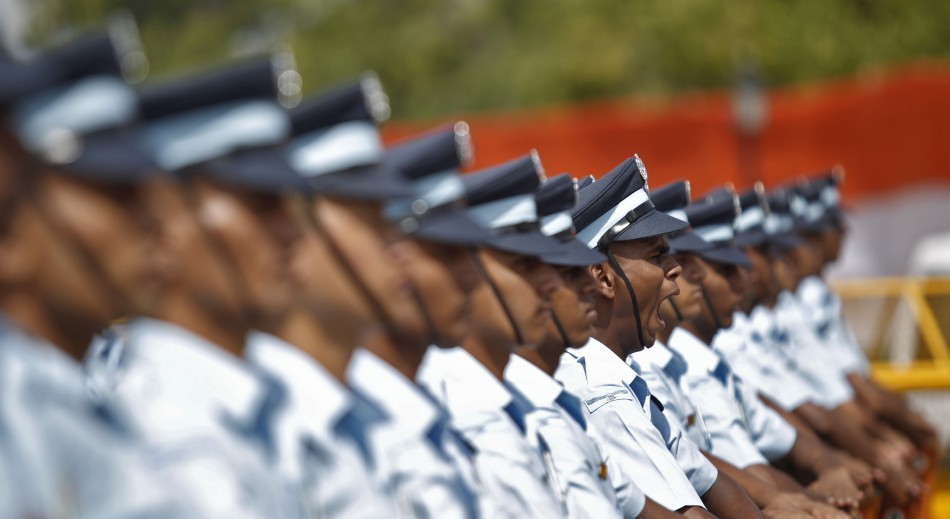 A soldier yawns as he stands with others at the India Gate war memorial before the arrival of India's President Pranab Mukherjee during a wreath laying ceremony during the country's Independence Day celebrations in New Delhi Independence Day