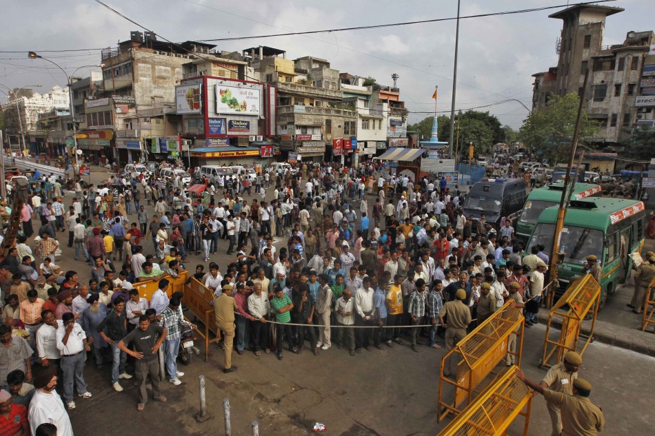 People gather where PM Singh is scheduled to address nation on Independence Day celebrations in Delhi Independence Day