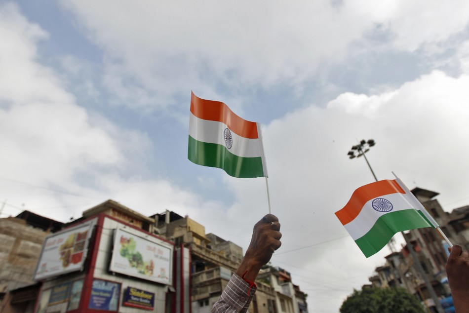 Man waves India's national flag where PM Singh will address nation during Independence Day celebrations in Delhi Independence Day