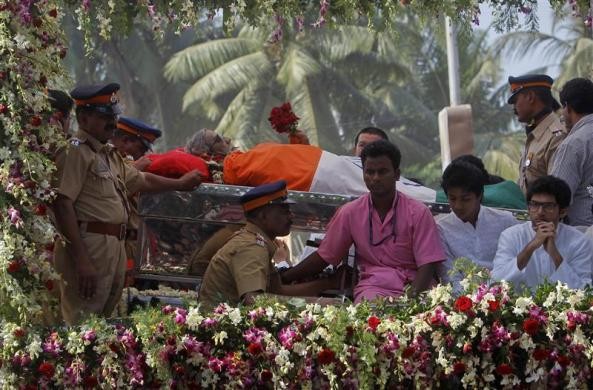 Fans And Mourners Throw Flowers On The Hearse That Carries The Casket