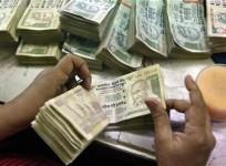 an-employee-counts-rupee-notes-at-a-cash-counter-inside-a-bank-in-kolkata-june-18-2012