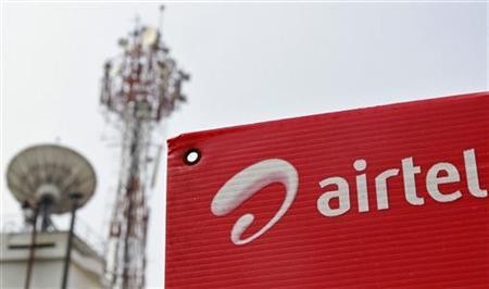 A Bharti Airtel advertisement board is installed against the backdrop of company's telecommunication tower in Kochi November 30, 2012.