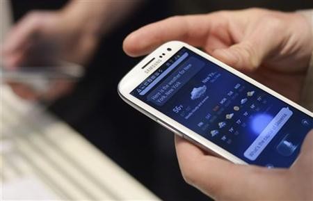 A man uses Samsung Electronics' new Samsung Galaxy SIII smartphone during its launch at The Earls Court Exhibition Centre in London