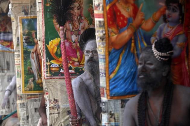 Naga Sadhus or Hindu holymen sit under their temporary shelters Naga Sadhus