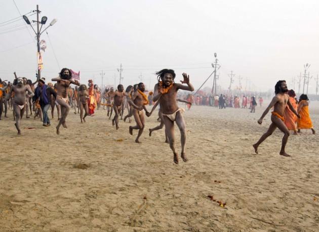 Naga sadhus, or Hindu holymen, run to attend the first 'Shahi Snan' (grand bath) at the ongoing Naga Sadhu