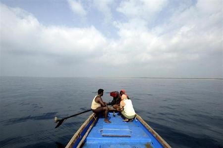 Fishermen sit on a boat in the Bay of Bengal near Gundalaba village, about 100 km (62 miles) east from Bhubaneswar, March 14, 2007. (representational image)