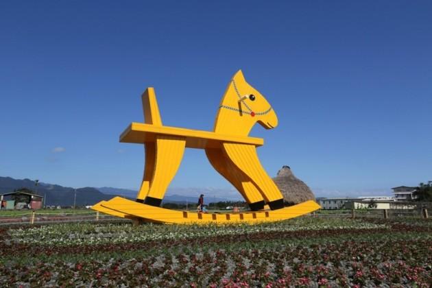 A 6.5 metres trojan stands amidst flowers ahead of the upcoming Chinese lunar New Year in Yilan county, southern Taiwan, January 23, 2014. REUTERS/Patrick Lin Chinese New Year 2014