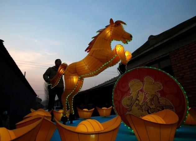 A worker tests the lights in a horse-shaped lantern during a photo opportunity ahead of the upcoming Chinese lunar New Year at a lantern factory outskirt of Beijing January 22, 2014. REUTERS/Kim Kyung-Hoon Chinese New Year 2014