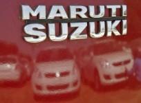 a-worker-cleans-a-maruti-suzuki-swift-dzire-car-as-he-is-reflected-in-a-car-at-the-company039s-stock-yard-at-sanand-in-gujarat