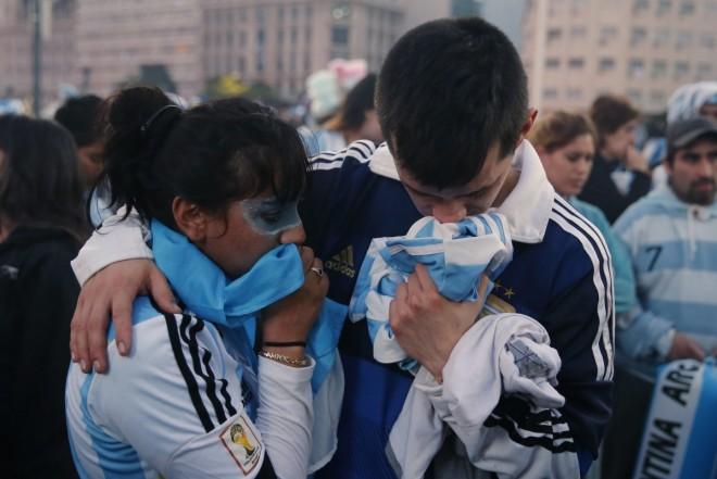 Argentina's fans react after Argentina lost to Germany in their 2014 World Cup final soccer match in Brazil, at a public square viewing area in Buenos Aires Argentina fans