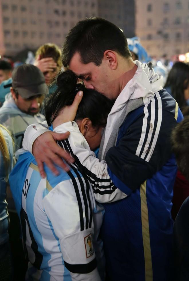 Argentina's fans react after Argentina lost to Germany in their 2014 World Cup final soccer match in Brazil, at a public square viewing area in Buenos Aires Argentina fans