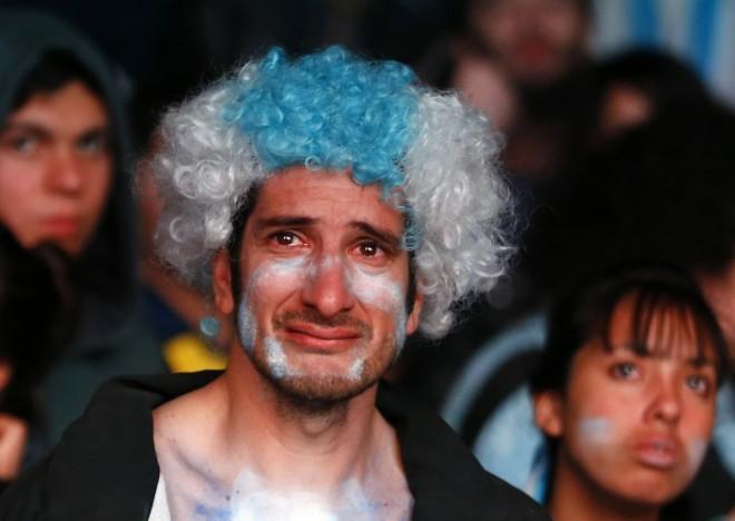 Argentina fans react after Argentina lost to Germany in 2014 World Cup final soccer match in Brazil, at public square viewing area in Buenos Aires Argentina fans