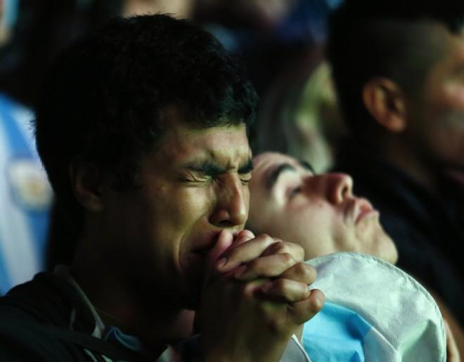 Argentina fan reacts after Argentina lost to Germany in 2014 World Cup final soccer match in Brazil, at public square viewing area in Buenos Aires Argentina fan