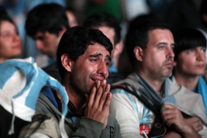Argentina's fans react after Argentina loss to Germany in their 2014 World Cup final soccer match in Brazil, at a public square viewing area in Buenos Aires Argentina fans